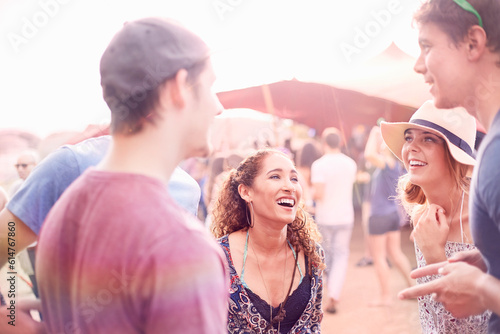 Young friends hanging out talking at music festival