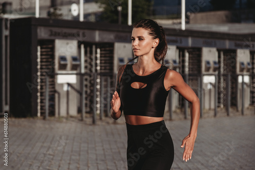 Beautiful young fit tanned caucasian woman running