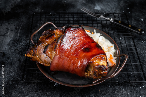 Traditional German cuisine Roasted pork knuckle Schweinshaxe with Sauerkraut. Black background. Top view