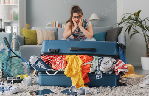 Stressed woman packing for a vacation