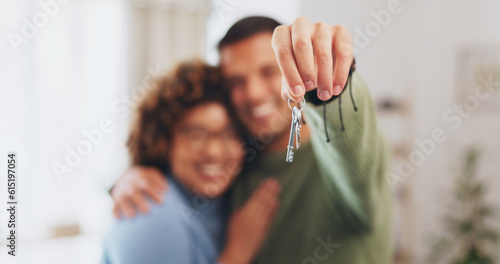 Hand, keys and a home owner couple proud of their real estate property investment or purchase. House, mortgage or beginning with a blurred background man and woman together in their new apartment