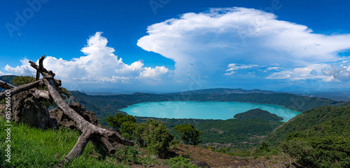 Aerial view of Coatepeque lake in El Salvador, in the season where its waters turn turquoise with the sky with storm clouds