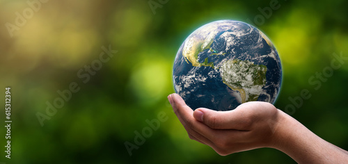 globe blue on hands in green blurred nature background, earth in adult hands , earth day, world day, energy saving concept, Elements of this image furnished by NASA.
