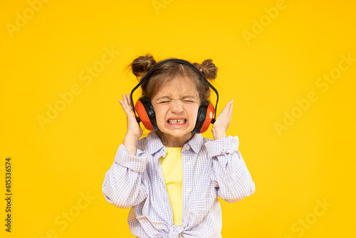 A girl in headphones for noise isolation