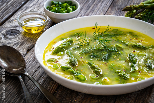 Asparagus soup on wooden table 