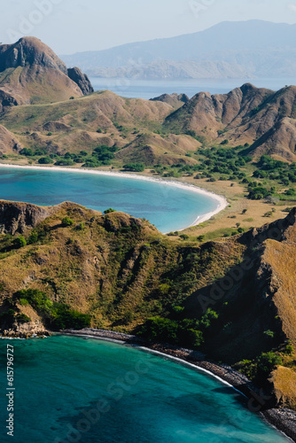 Panorama of Padar Island, in Indonesia, from a height, view of the bays, blue ocean, dry grass.
