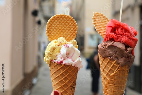 Ice cream in Alghero, Sardinia. Hand holding Italian gelato ice cream in cone.