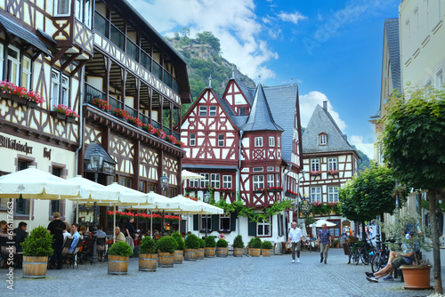 view beautiful ancient European Bacharach city, tourists walk along historical streets, sitting in cafes, old half-timbered houses, tourism in Rhineland-Palatinate, Bacharach, Germany, June 17, 2023