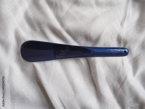 shoehorn on bed sheet