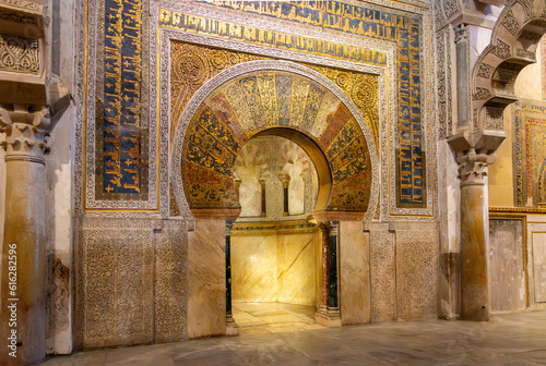 The golden arched mihrab or prayer nice used to identify the wall that faces Mecca inside the great Mezquita mosque cathedral in Cordoba, Spain.