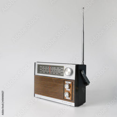 Authentic radio from the 70s. Front right view. Isolated on white background. Traces of time and scuffs on the case