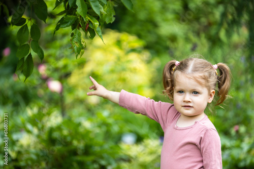 toddler girl is interested in outdoor nature