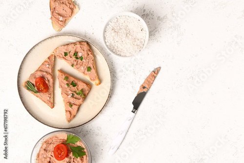 Plate of sandwiches with tasty pate and sea salt on light background