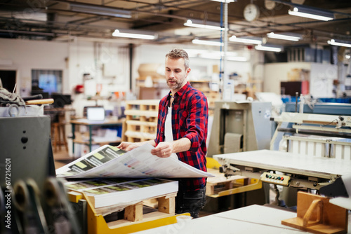 Mid adult man working in a printing press office