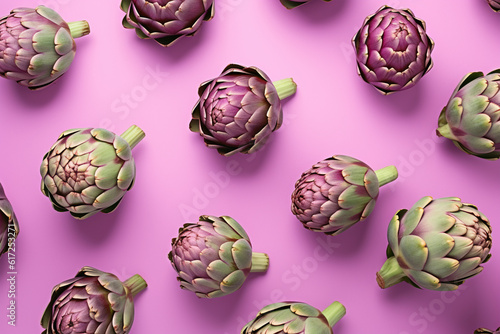 Top view of artichoke vegetables on pastel violet background