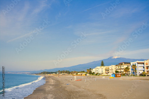 Beach in Recanati near Giardini Naxos, Taormina, Sicily, Italy, with Entna in the background