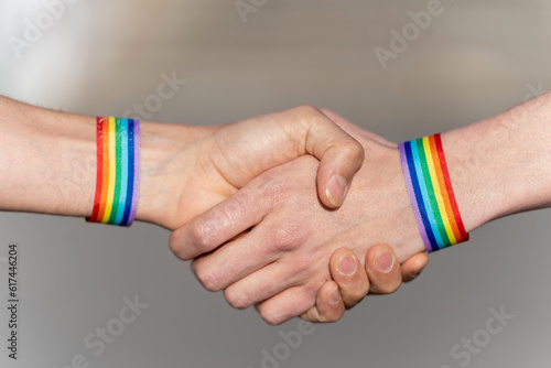 Close-up of a handshake with wristbands supporting the lgtbi movement. lgtbiq concept