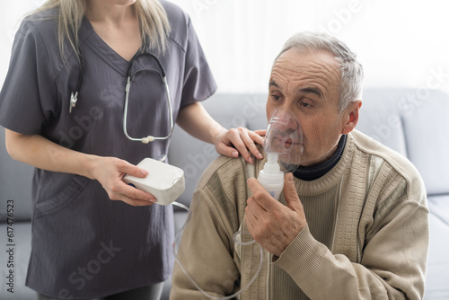Elderly Senior Man nursing care wear oxygen inhaler device for helping breath respiratory. Oxygen Concentrator portable