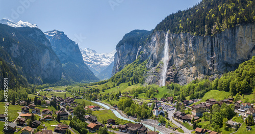 Aerial panorama image of the beautiful village Lauterbrunnen with Staubbach waterfall and snow mountain Jungfrau at the background