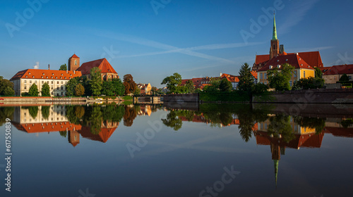 Beautiful old Ostrow Tumski and library and church on Sand Island in Wroclaw in Poland with reflection in Odra river