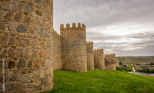 Walls of the historic city of Avila,at the blue hour, in Spain. the old city of Avila and its extramural churches were declared a World Heritage site by UNESCO