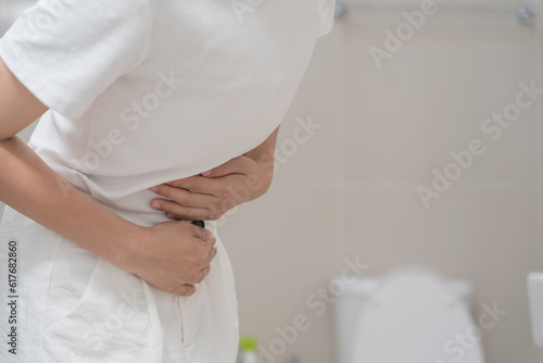 Constipation and diarrhea in bathroom. Hurt woman touch belly stomach ache painful. colon inflammation problem, toxic food, abdominal pain, abdomen, constipated in toilet, stomachache, Hygiene
