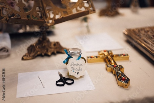 Gift jar with 'Amira Nicole' text near scissors and white paper placed on table