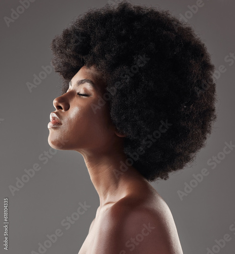 Natural haircare, profile and black woman with afro hairstyle, beauty and skincare on grey background. Hair care, cosmetics and beautiful face of African model with skin glow and shine in studio.