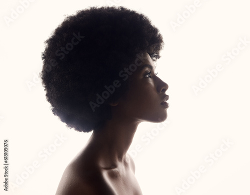 Hair care, silhouette and profile of black woman with afro hairstyle, beauty and skincare on grey background. Natural haircare, cosmetics and face of African model with skin glow and shine in studio.