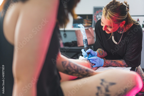 tattoo artist applying ink on a customer's body, tattoo-making process. High quality photo