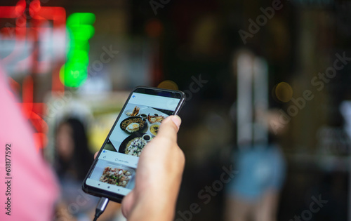 Close up hand holding mobile phone with order food