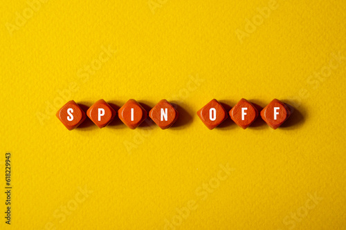 Spin off - word concept on building blocks, text