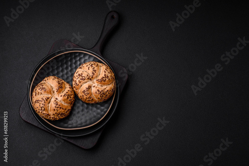 Delicious freshly baked crispy bun or kaiser roll with sesame seeds