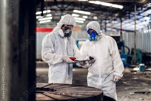 Scientist wear Chemical protection suit check danger chemical, working at dangerous zone in Red and White Lines of barrier tape. Red and white Hazardous restricted area factory safety worker industry