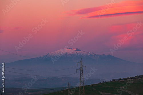 Etna volcano on pink sky at sunset seen from central Sicily
