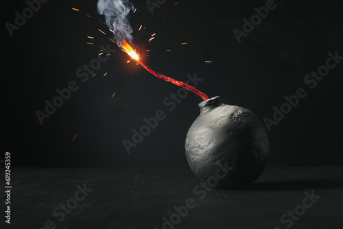 Round black bomb with lit fuse burning with sparks. Symbolizing fear, crisis, or dangerous violence.