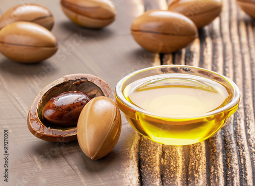 ARGAN SEEDS on a wooden background. Argan oil and argan concept