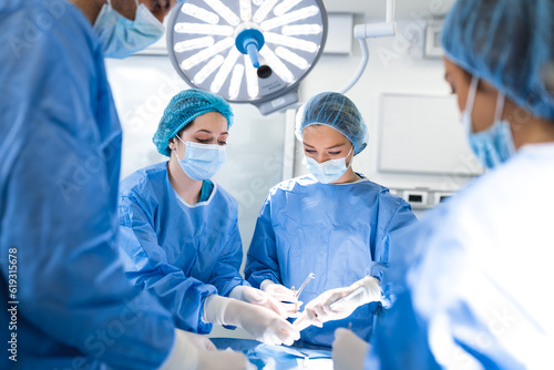 Doctor and assistant nurse operating for help patient from dangerous emergency case .Surgical instruments on the sterile table in the emergency operation room in the hospital.Health care and Medical