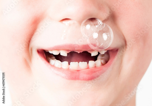 Children's cold. Children's runny nose known as baby snot. Funny big bubble of snot from child nose.