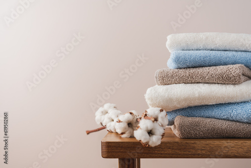 Stack of blue white beige cotton terry towels close up view. Bathroom interior details with copy space