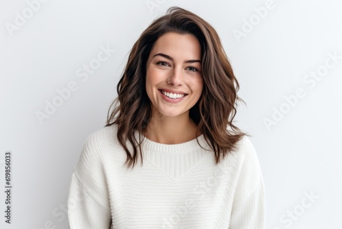 Medium shot portrait photography of a grinning woman in her 30s wearing a cozy sweater against a white background