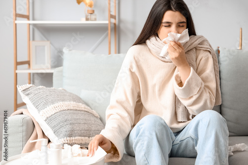 Sick woman with runny nose at home