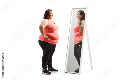 Overweight woman looking at a slimmer version of herself in the mirror