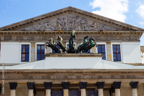 The building of National Opera House in Warsaw (also known as Opera Narodowa, Teatr Wielki) with statue of Apollo on horse drawn chariot and relief pediment architecture