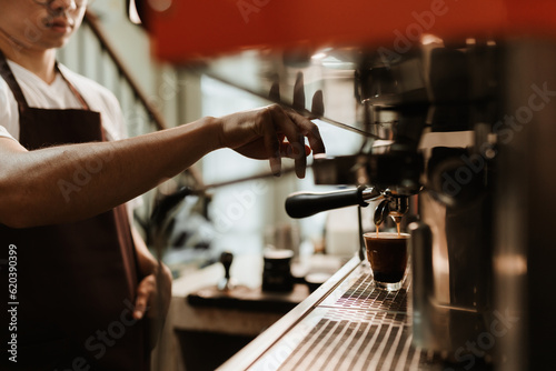 Selective focus, Hand of Barista making coffee with espresso coffee machine in coffee shop. Closeup, Coffee making concept.