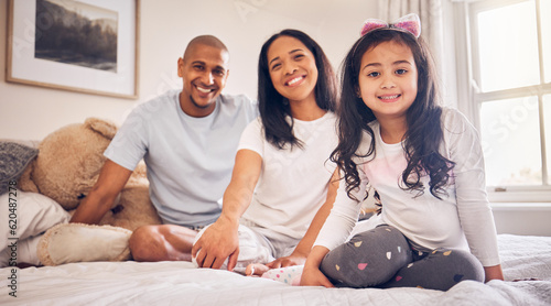Family, relax and happy portrait on a bed at home with a smile and comfort for quality time. Man, woman or parents and a latino girl kid together in the bedroom for morning bonding with love and care