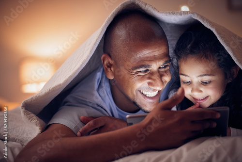 Happy father, child and tablet at night, bedroom or home for online games, reading ebook or storytelling with blanket. Excited dad, girl and streaming cartoon movie on digital tech, media or internet