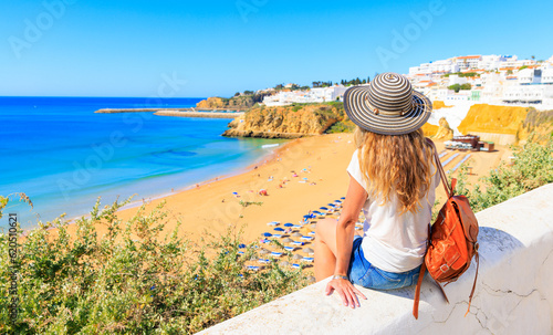 travel destination in Portugal- idyllic beach in Algarve with woman enjoying the view