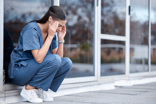 Anxiety, doctor or a woman with a headache from healthcare, surgery mistake or death at a hospital. Sad, depressed and a tired female nurse with a migraine or burnout from medical career at a clinic