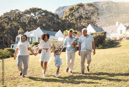 Holding hands, kids and a blended family walking in the garden of their home together during summer. Grandparents, parents and children on grass in the backyard of a house for bonding during a visit